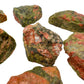 Held in hand, a Unakite raw stone, hand-selected from Northern Cape, South Africa.