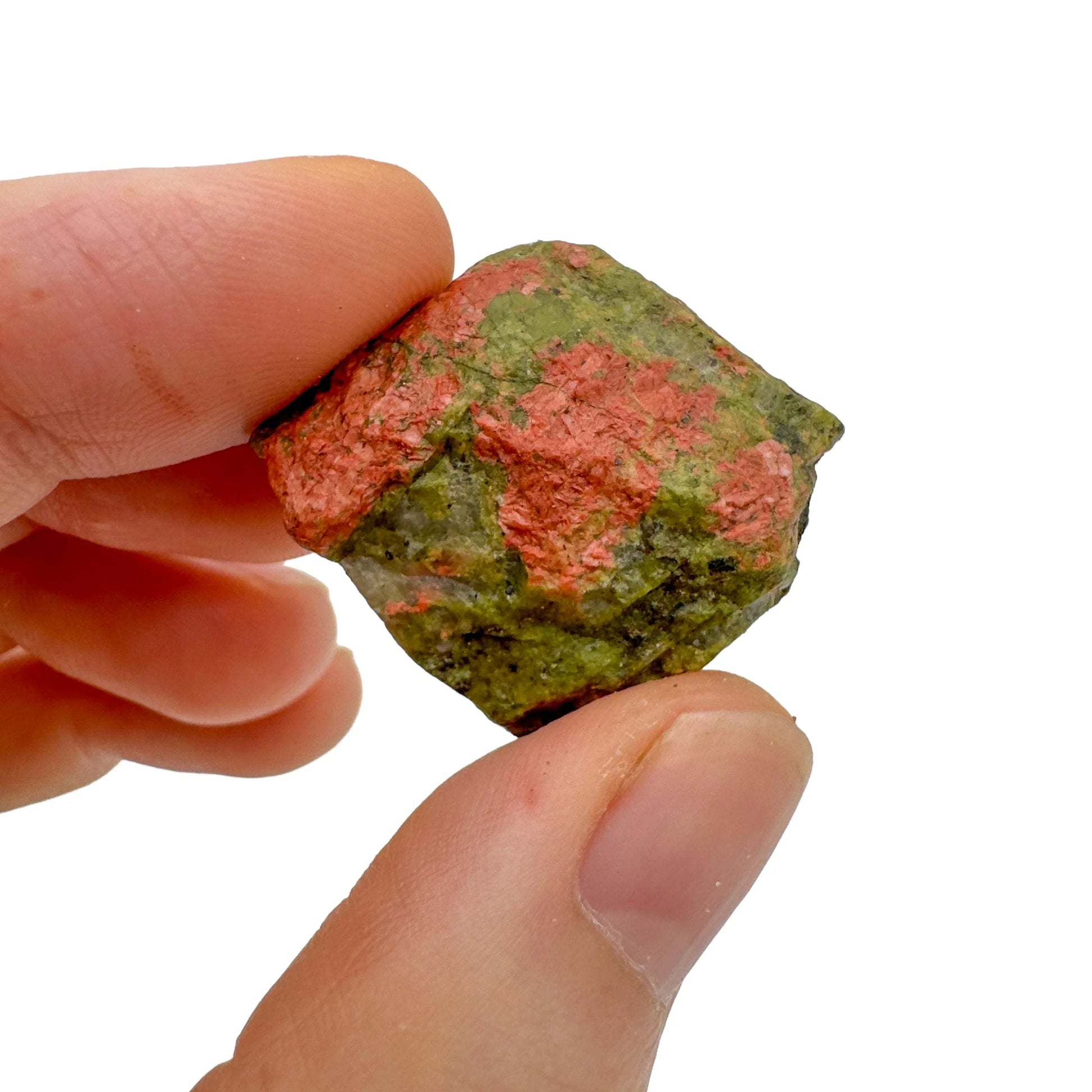 Holding an Unakite raw crystal, with hand-sized presence.