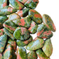 Bottom side of Unakite tumbled stone, showing natural inclusions.