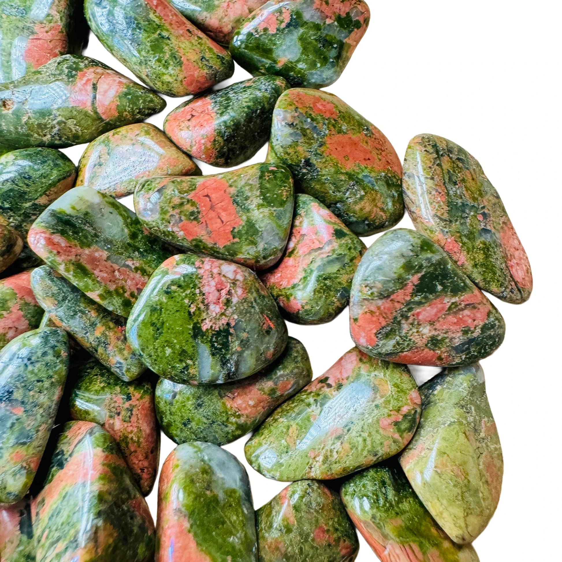 Bottom side of Unakite tumbled stone, showing natural inclusions.