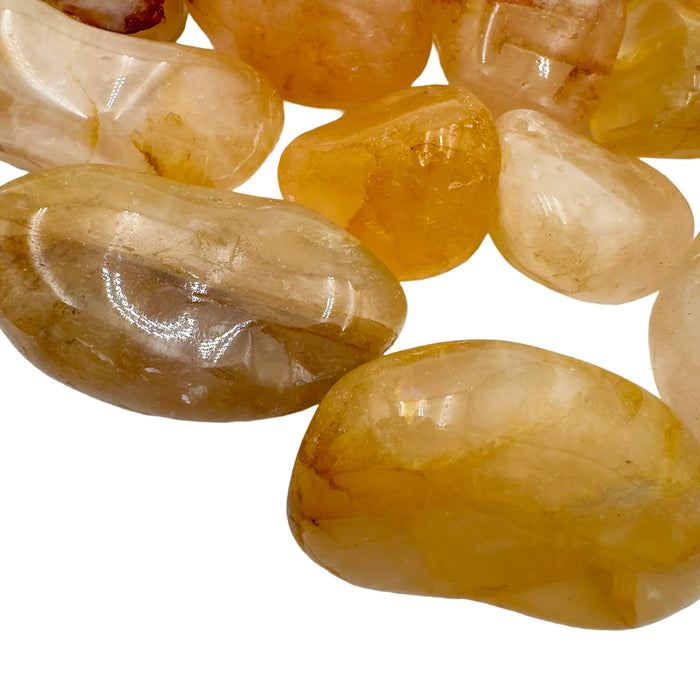 Sideways view of Golden Healer tumbled stone, sourced from Alaotra-Mangoro, Madagascar.