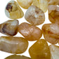 Aerial view of yellow Golden Healer tumbled stone, often paired with practices around Healing, showing characteristic color.