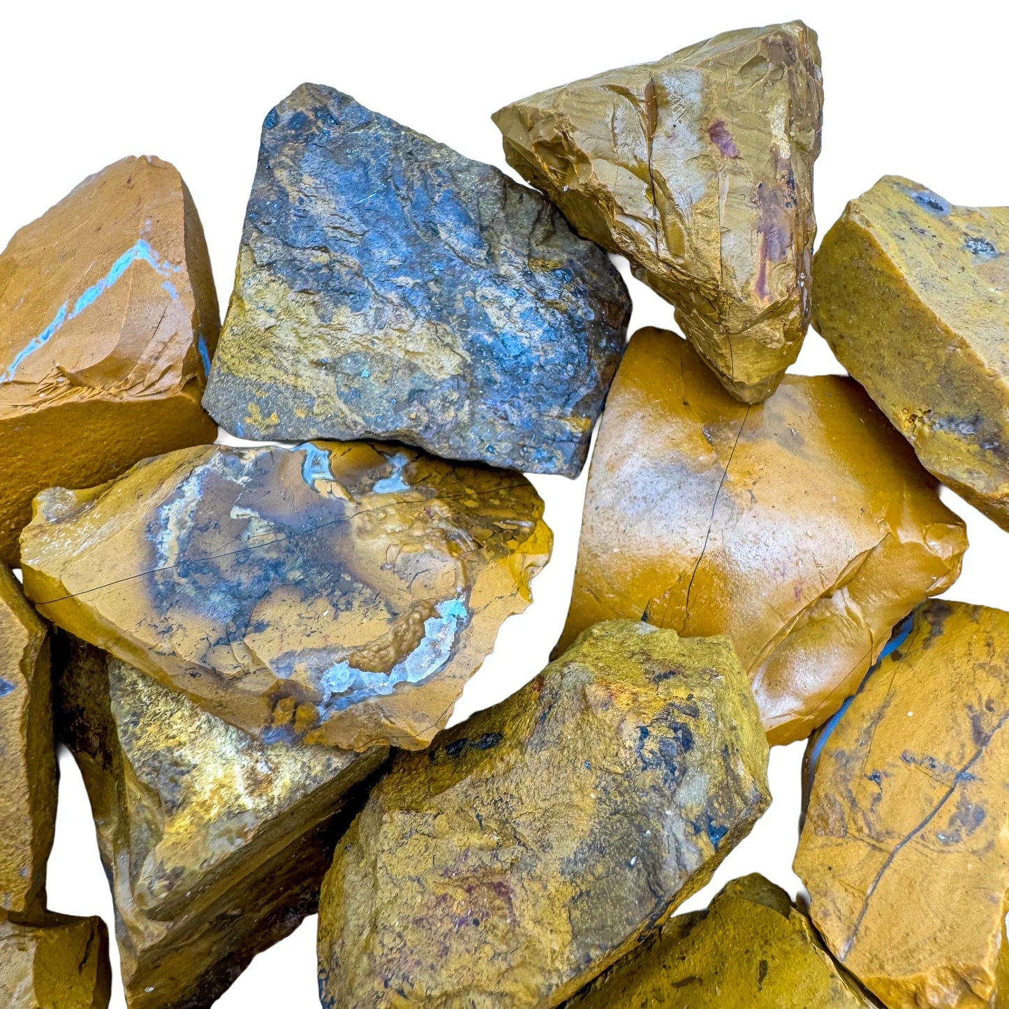 Scale reference of a Yellow Jasper raw stone held against natural backdrop.