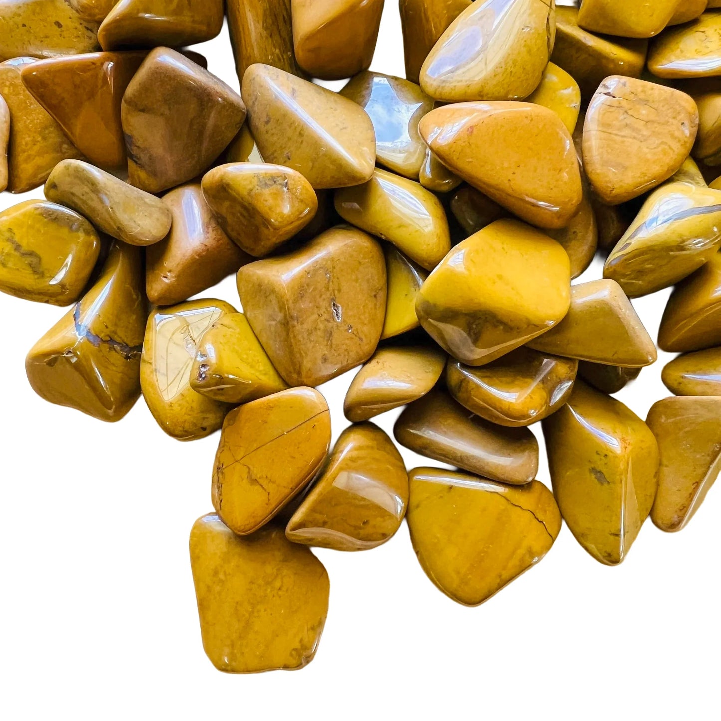 Natural light view of one Yellow Jasper tumbled stone for scale, sourced from Madagascar.