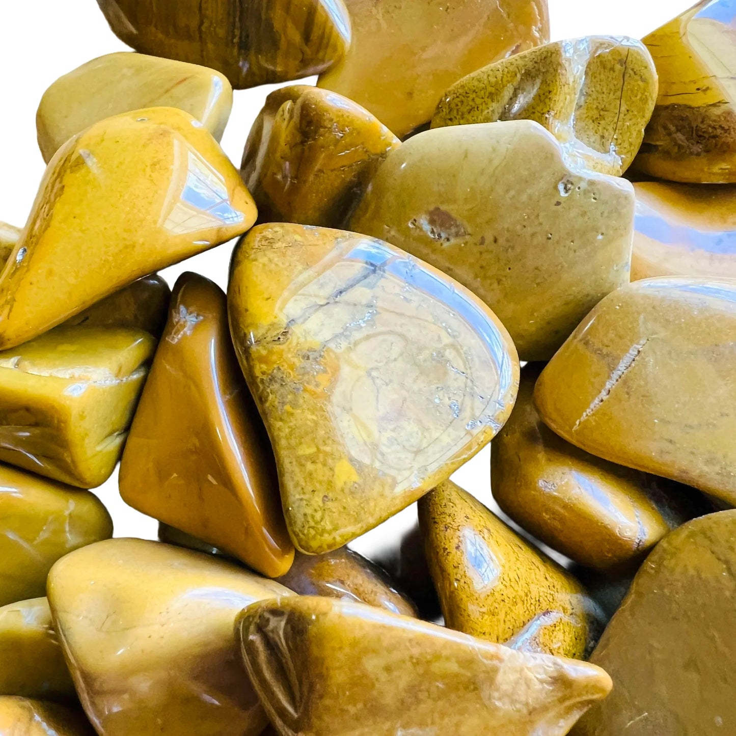 Bottom side of Yellow Jasper tumbled stone, Madagascar-sourced, showing color depth.