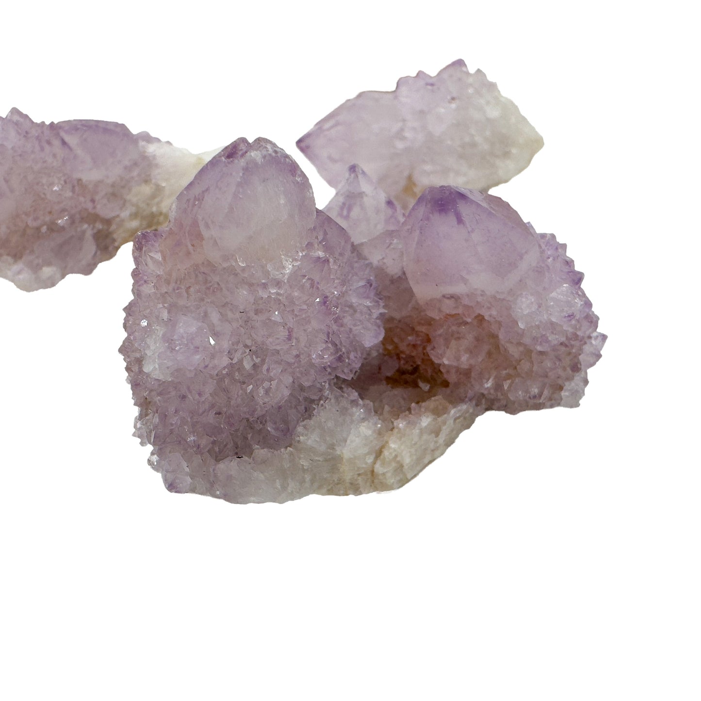 Two of the larger Spirit Quartz terminations shown up close, with clear violet tips above a dense collar of secondary growth.