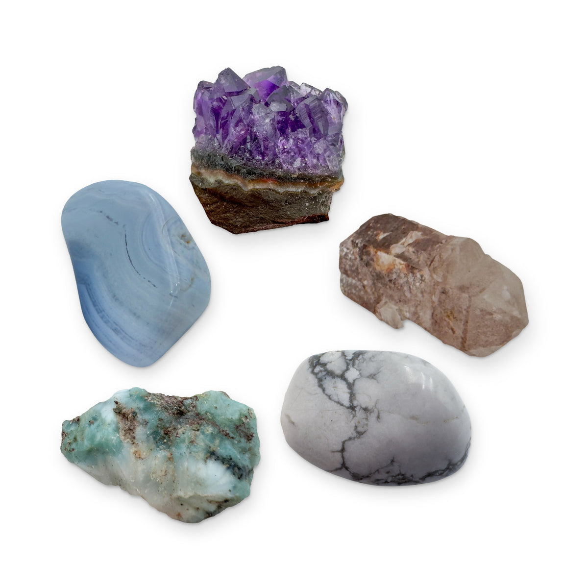 The Calm & Sleep Kit: blue lace agate, amethyst cluster, lithium quartz point, howlite and larimar, shown together on white