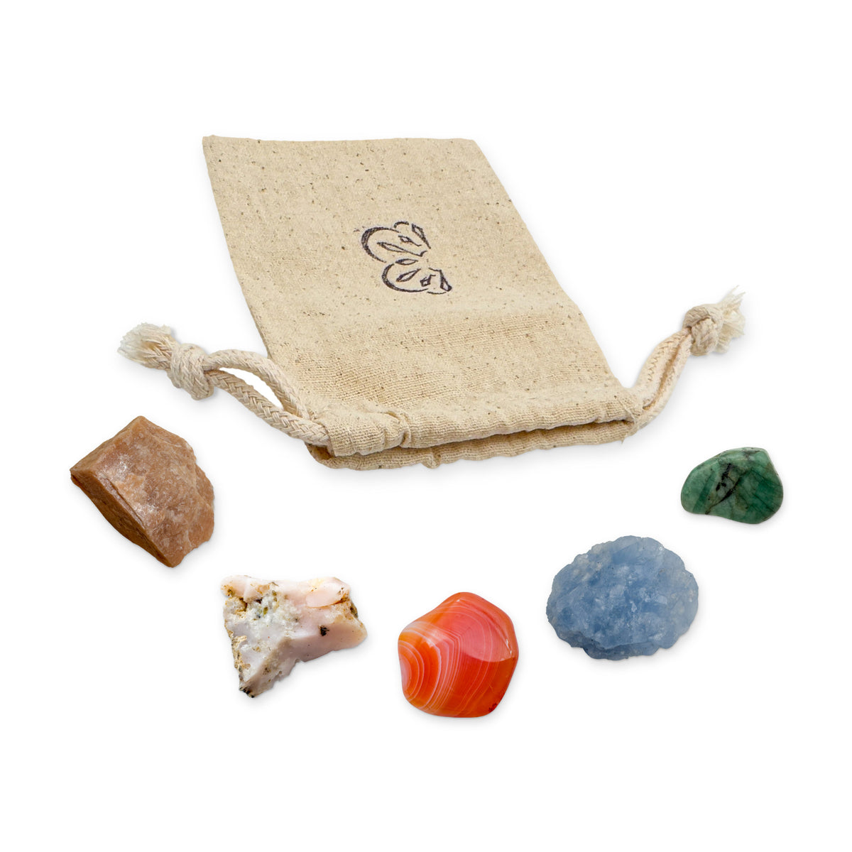 Cancer Crystal Kit: peach moonstone, pink opal, banded carnelian, blue calcite and emerald, arranged with the reusable cotton bag they come in, on white