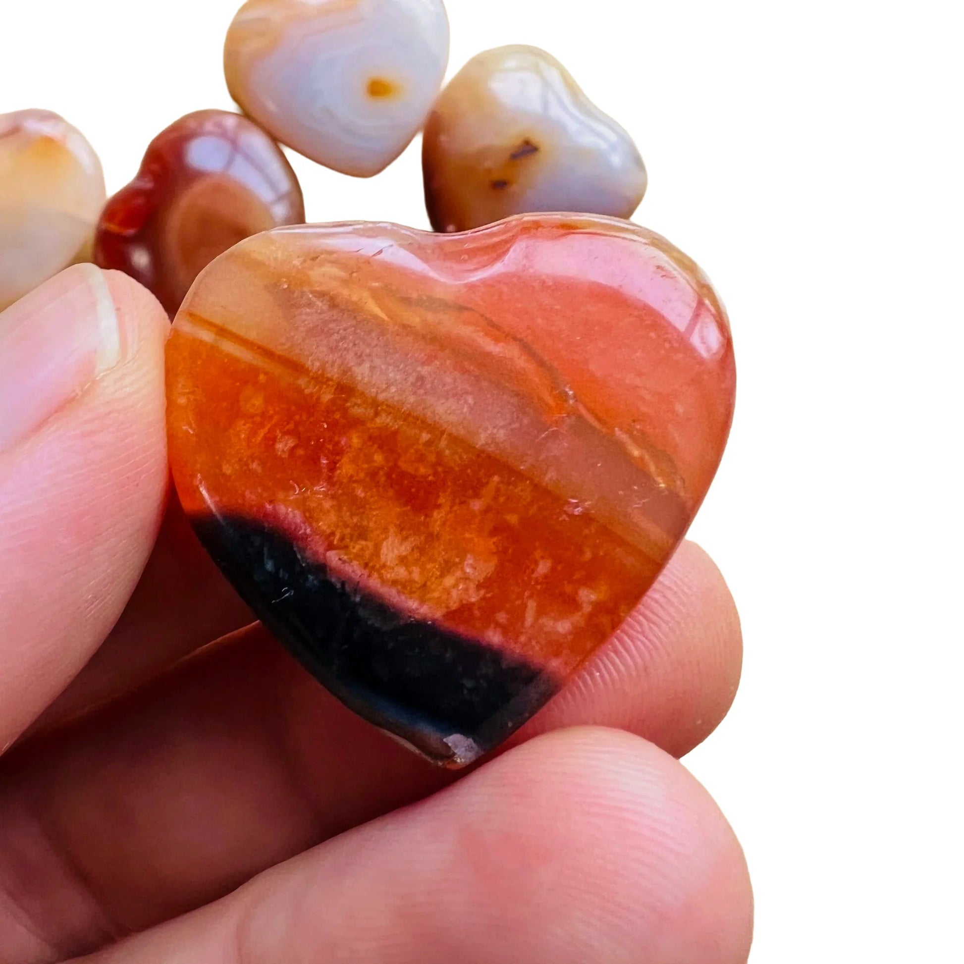 Detail shot of Grade AA Carnelian heart under natural light