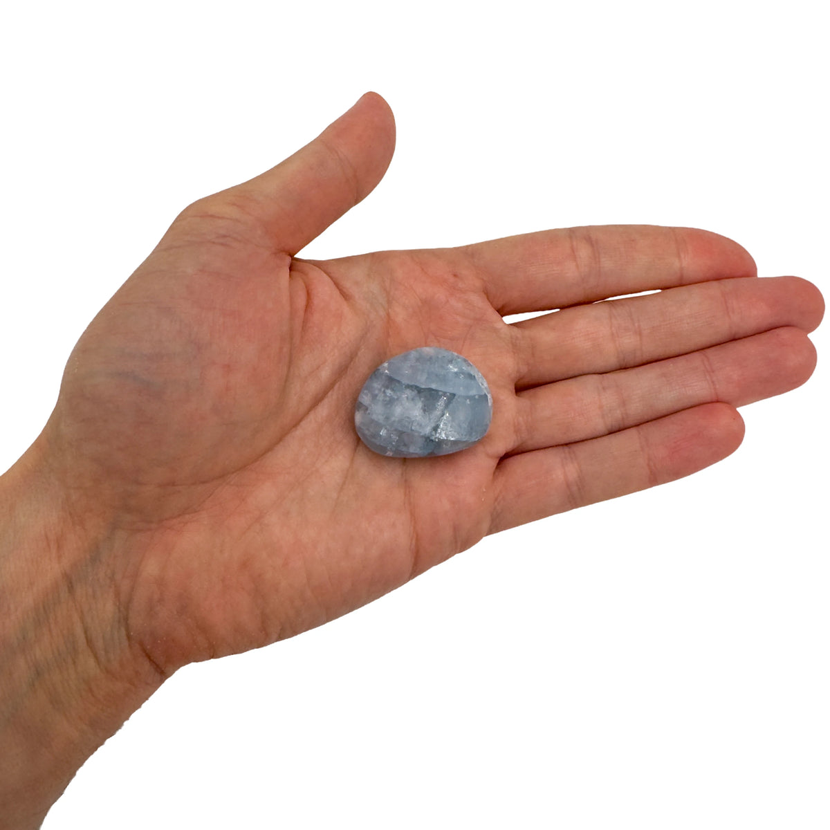 AA Grade Celestite palm stone held in hand for scale, from Madagascar