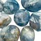 Reverse angle of Celestite palm stone, often paired with practices around Stress Relief.