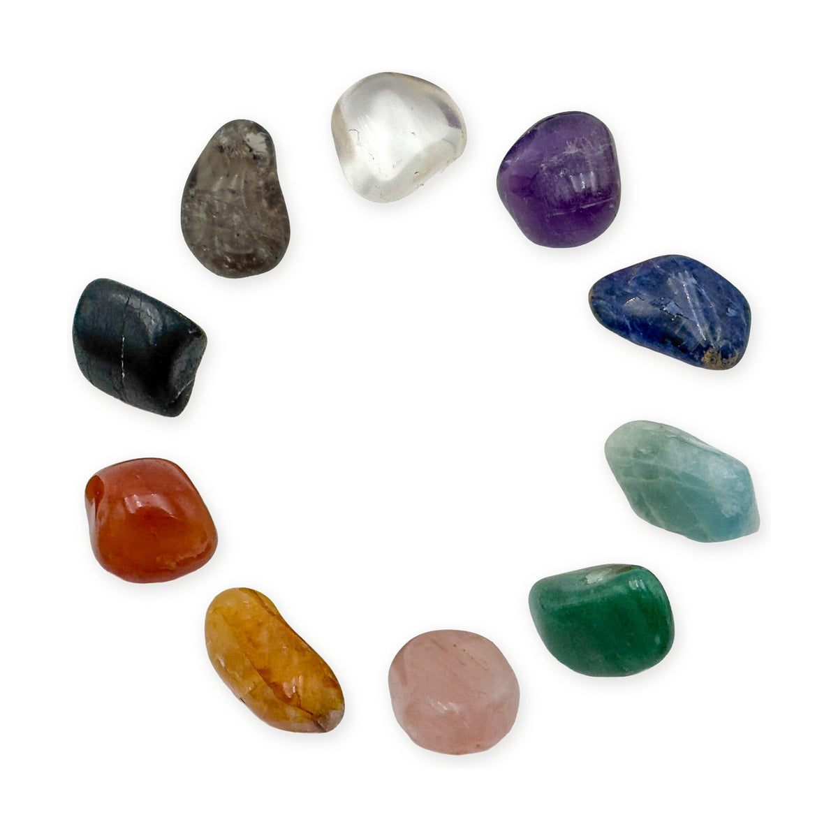 Ten tumbled chakra stones laid in a circle on white: clear quartz, amethyst, sodalite, aquamarine, green aventurine, rose quartz, golden healer, carnelian, black tourmaline and smoky quartz