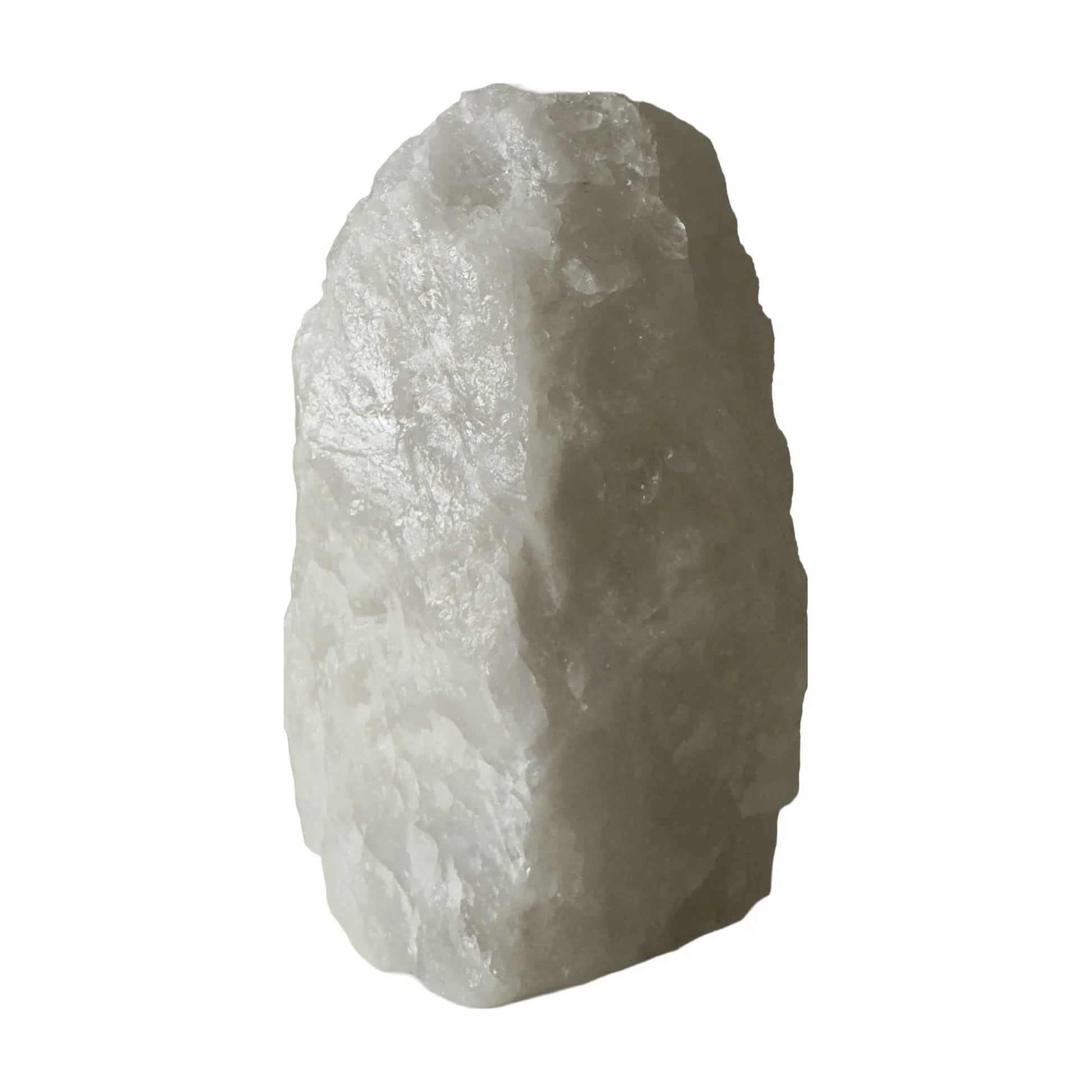 Clear quartz crystal lamp lit, soft warm glow through the stone, from Brazil
