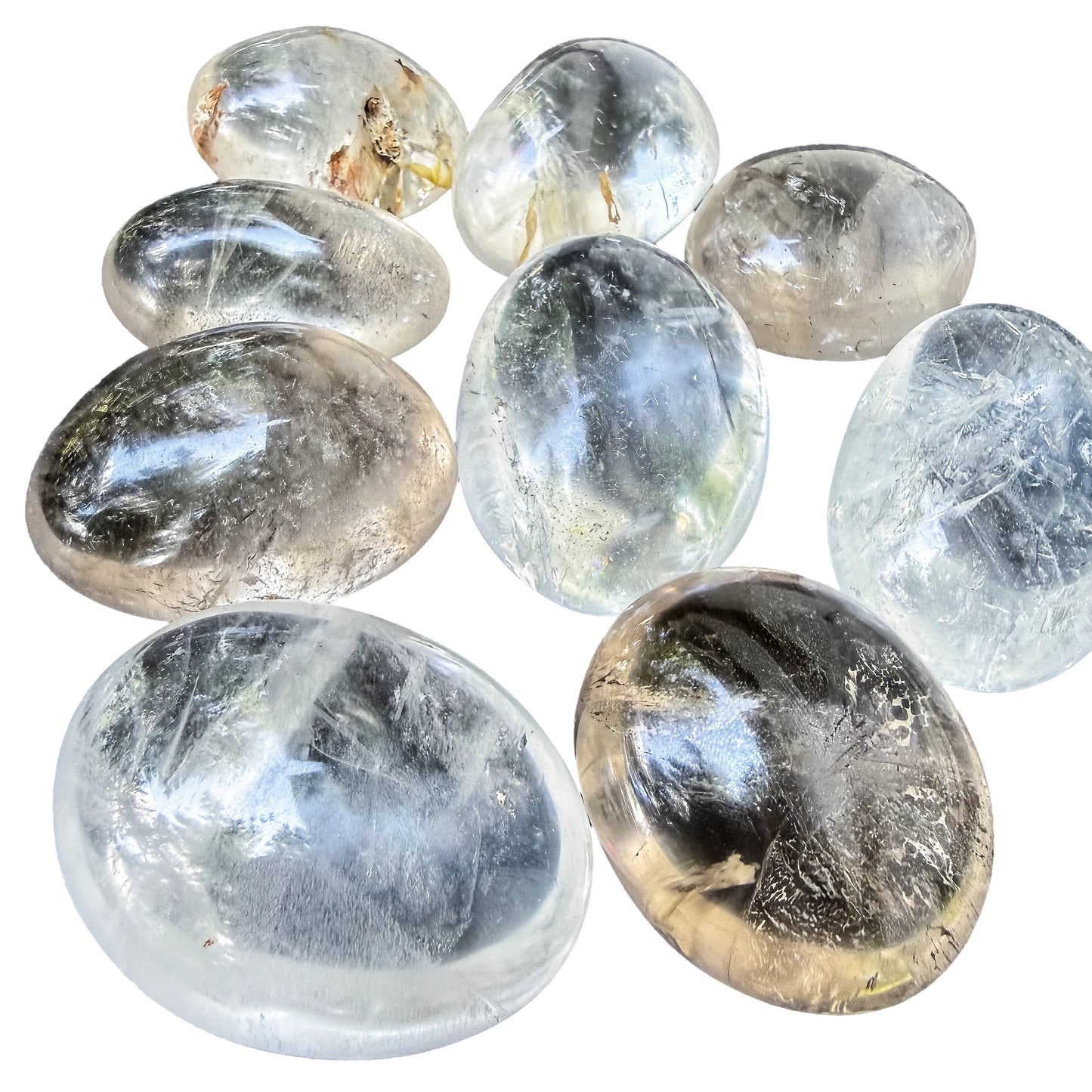 Clear Quartz palm stones arranged to show the range from medium to extra large