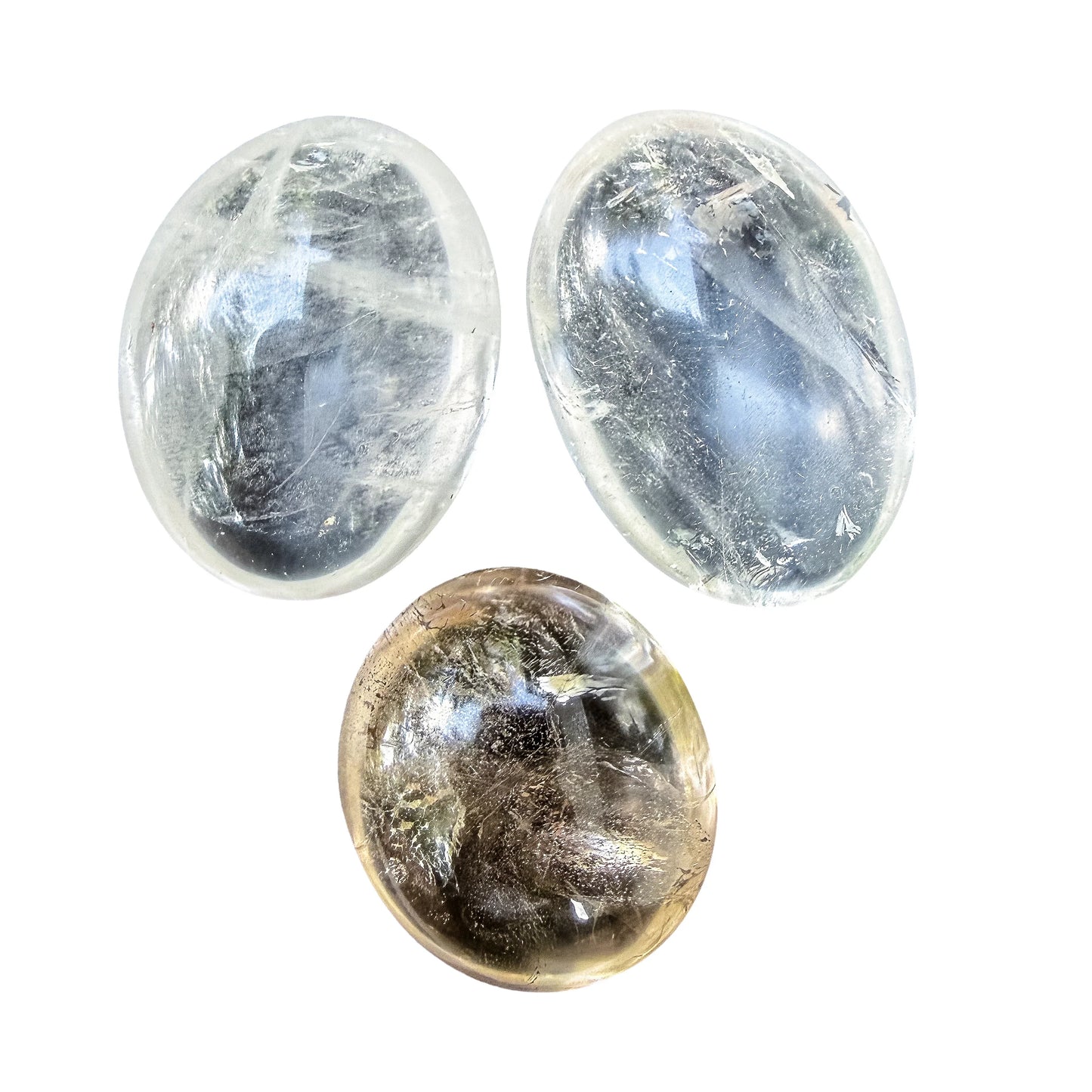 Three Clear Quartz palm stones side by side showing the three weight options