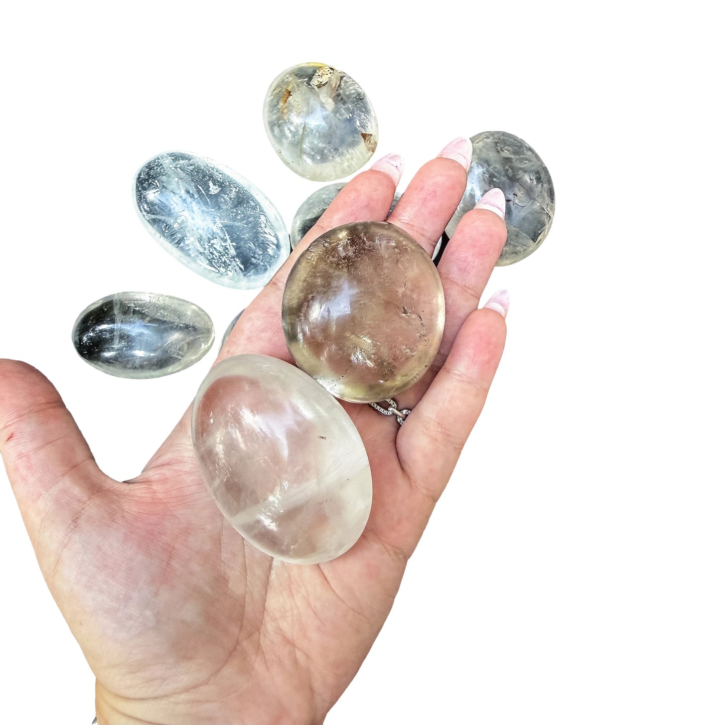 A Clear Quartz palm stone held in an open palm showing how it fills the hand