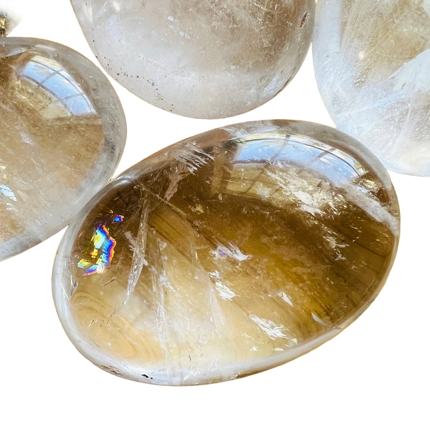 Detail shot showing Grade AA Clear Quartz palm stone, showing subtle veining, hand-selected from Vakinankaratra, Madagascar.