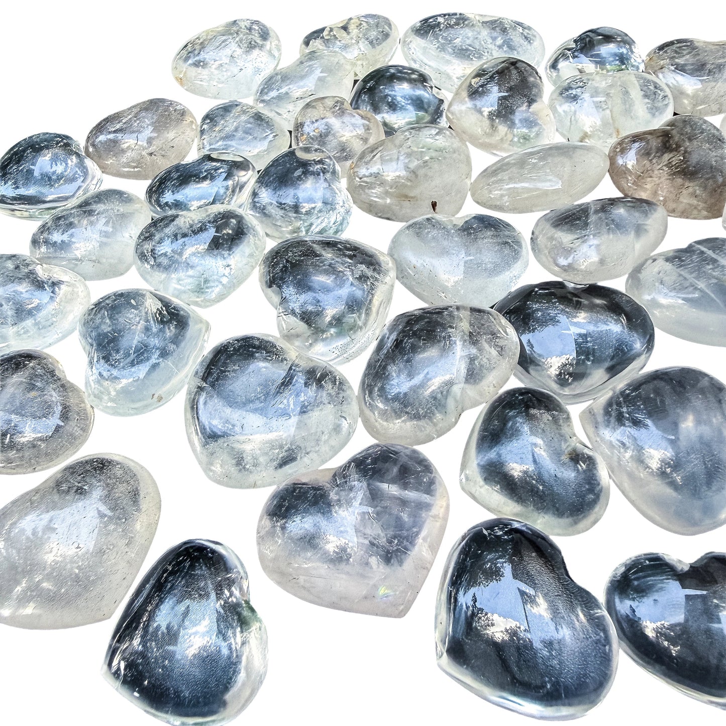 Three Clear Quartz hearts stacked to show the glassy polish and rounded backs