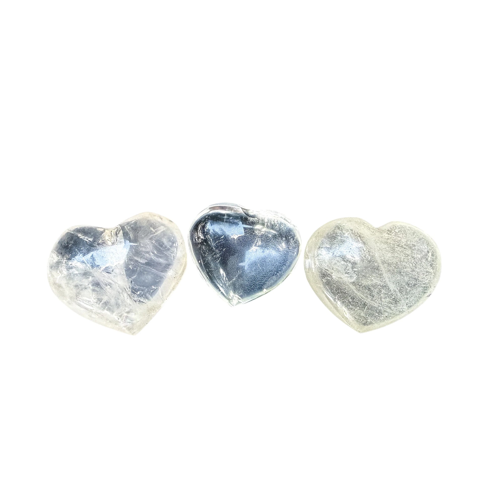 Clear Quartz hearts arranged in a row, each one reading a little differently