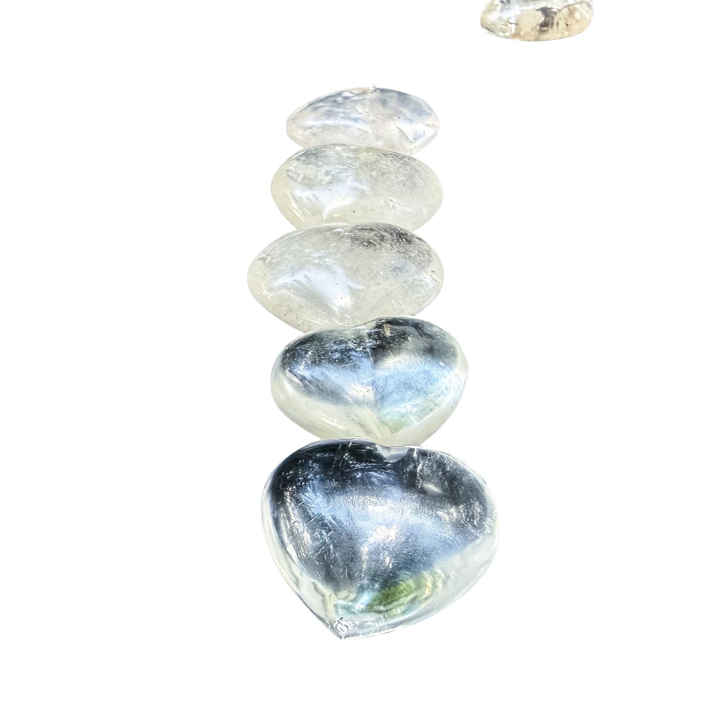 Clear Quartz hearts grouped to show color and clarity variation across the batch