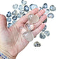 A Clear Quartz polished heart held in an open palm for scale