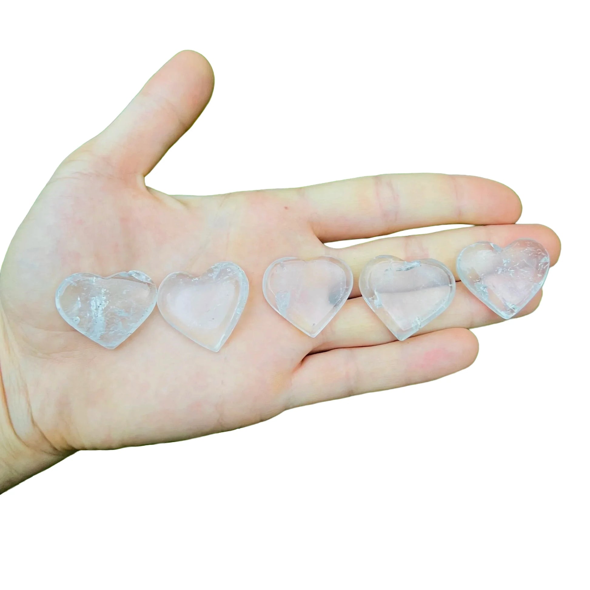 Near view of Clear Quartz polished heart, showing natural inclusions, kept close for Cleansing.