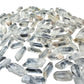 Overhead flat-lay of small Clear Quartz points spread evenly, showing how many come in a pound