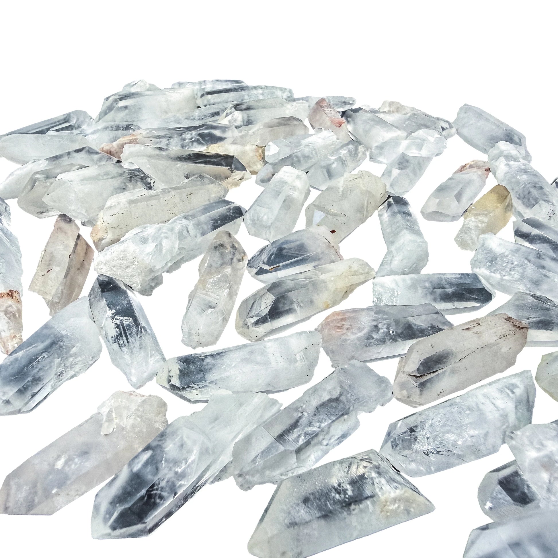 Angled view over a pile of larger Clear Quartz points with six-sided terminations visible
