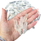 Several larger Clear Quartz points held in an open palm to show the 1 to 2 inch scale