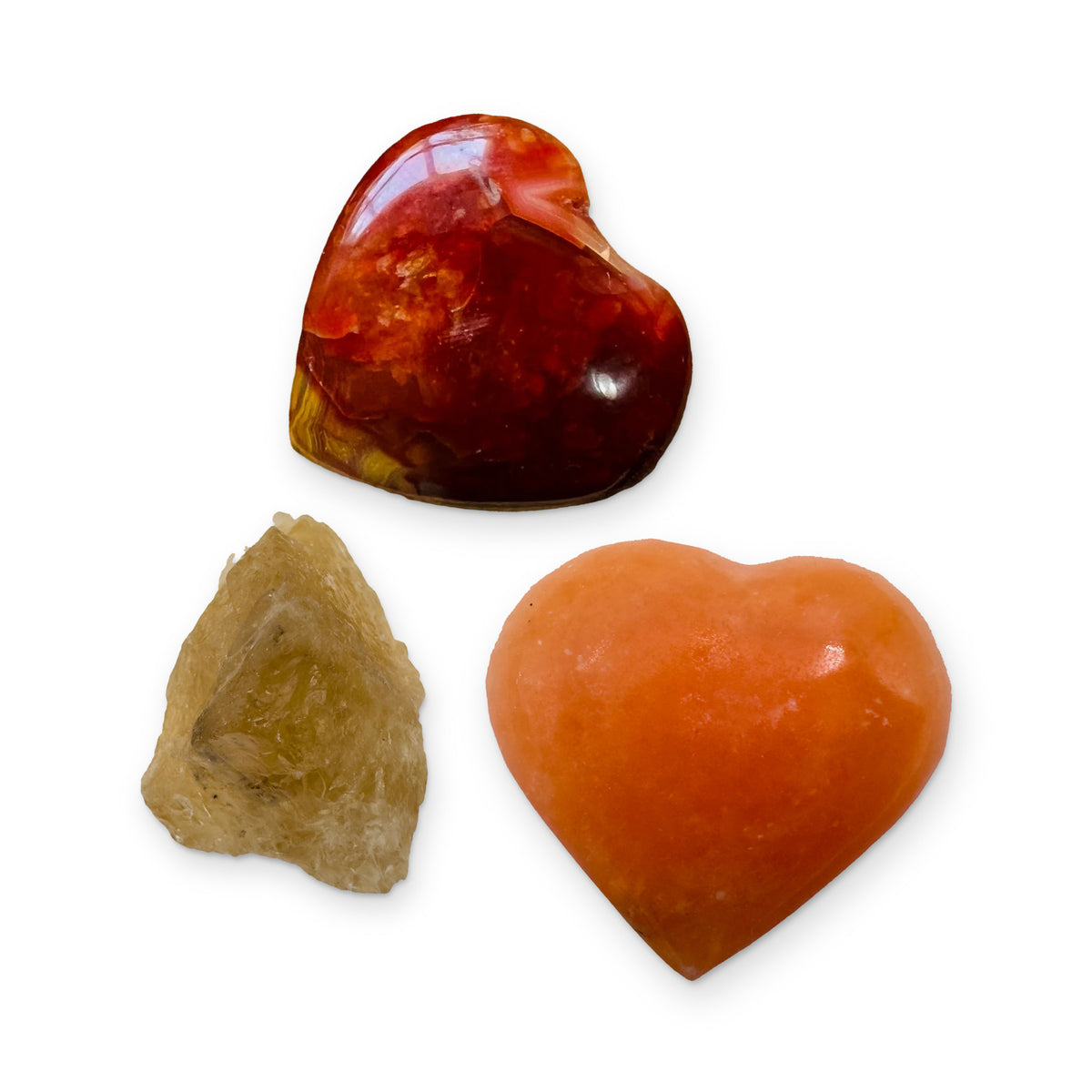 The Creativity Kit: carnelian heart, orange calcite heart and natural citrine, shown together on white