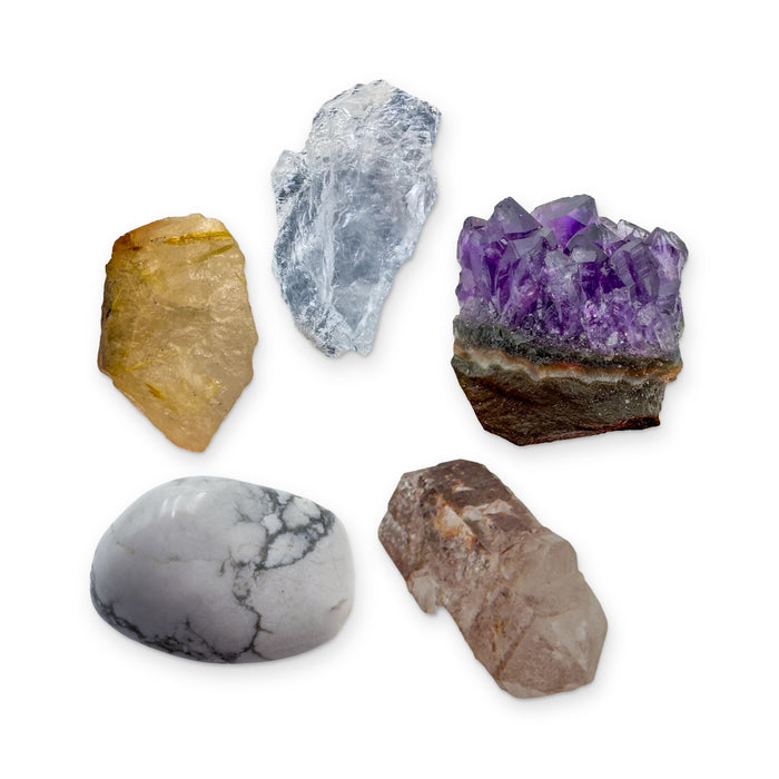 Crown Chakra Crystal Kit: clear quartz, amethyst cluster, lithium quartz point, howlite and rutilated quartz, shown together on white