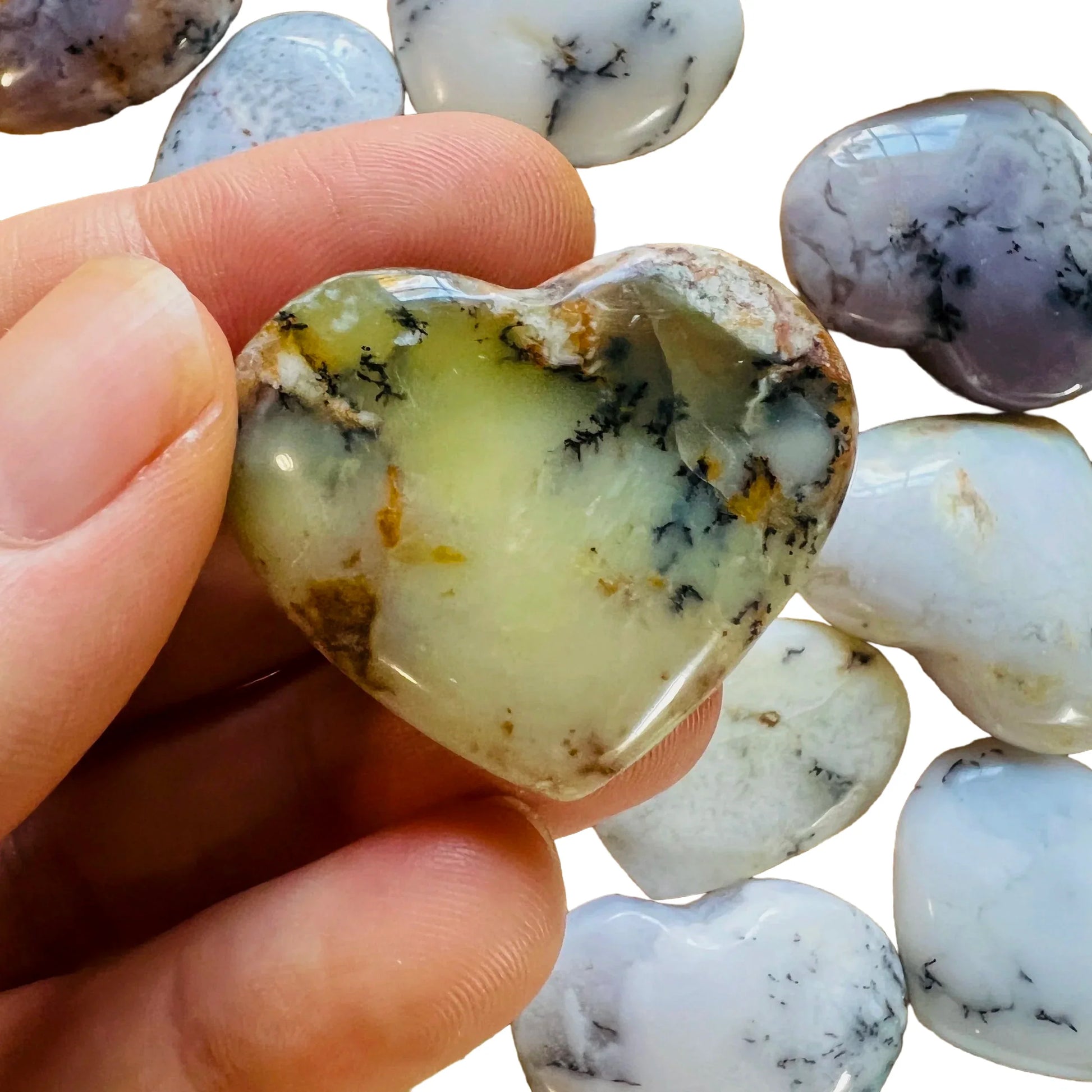 Hand-scale shot of one Dendritic Opal polished heart for scale, hand-selected from Atsinanana, Madagascar.