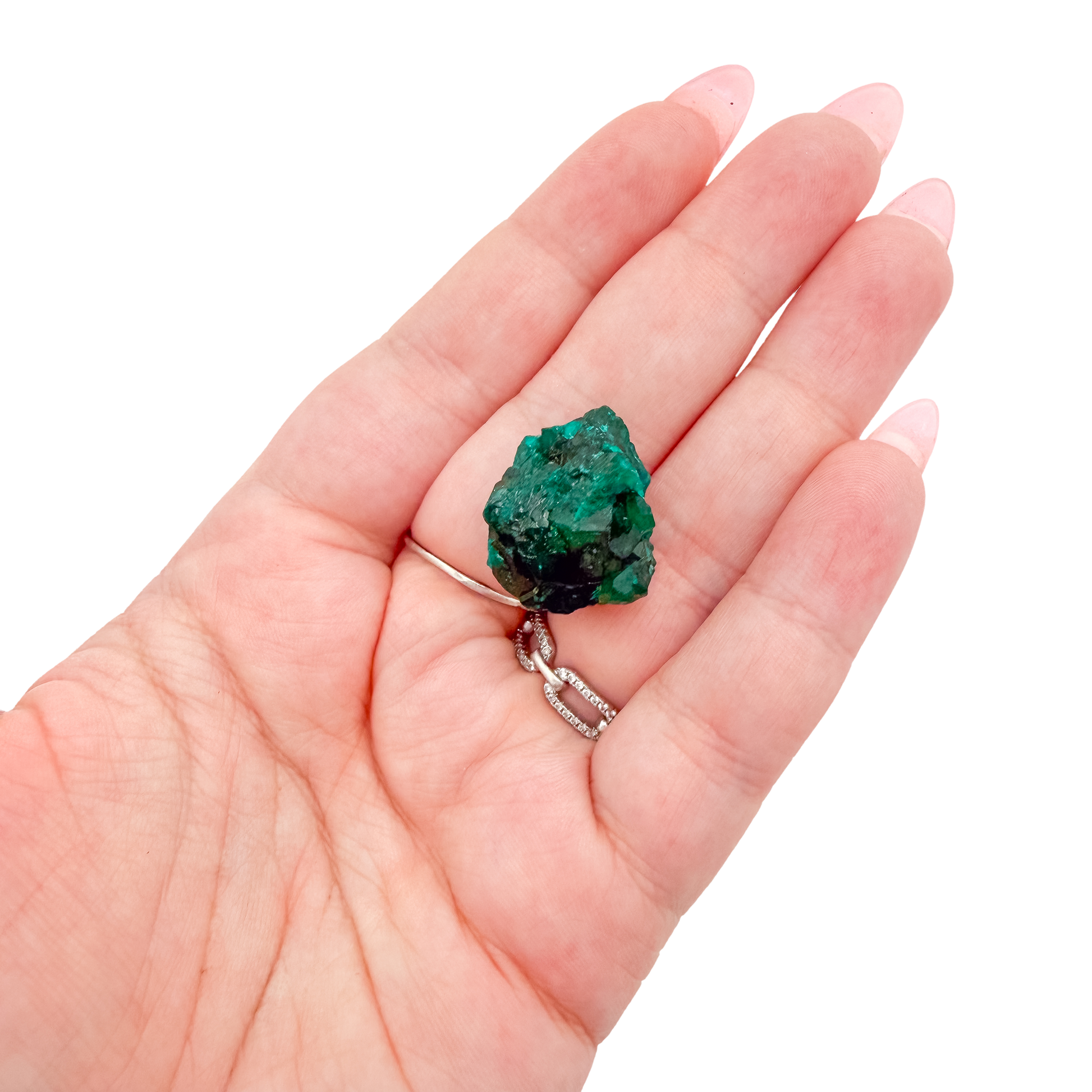 Hand holding the bright crystal face to show how small a 1.14 inch collector dioptase is