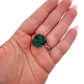 The elongated matrix held in a hand, showing the true scale of this 1.49 inch dioptase