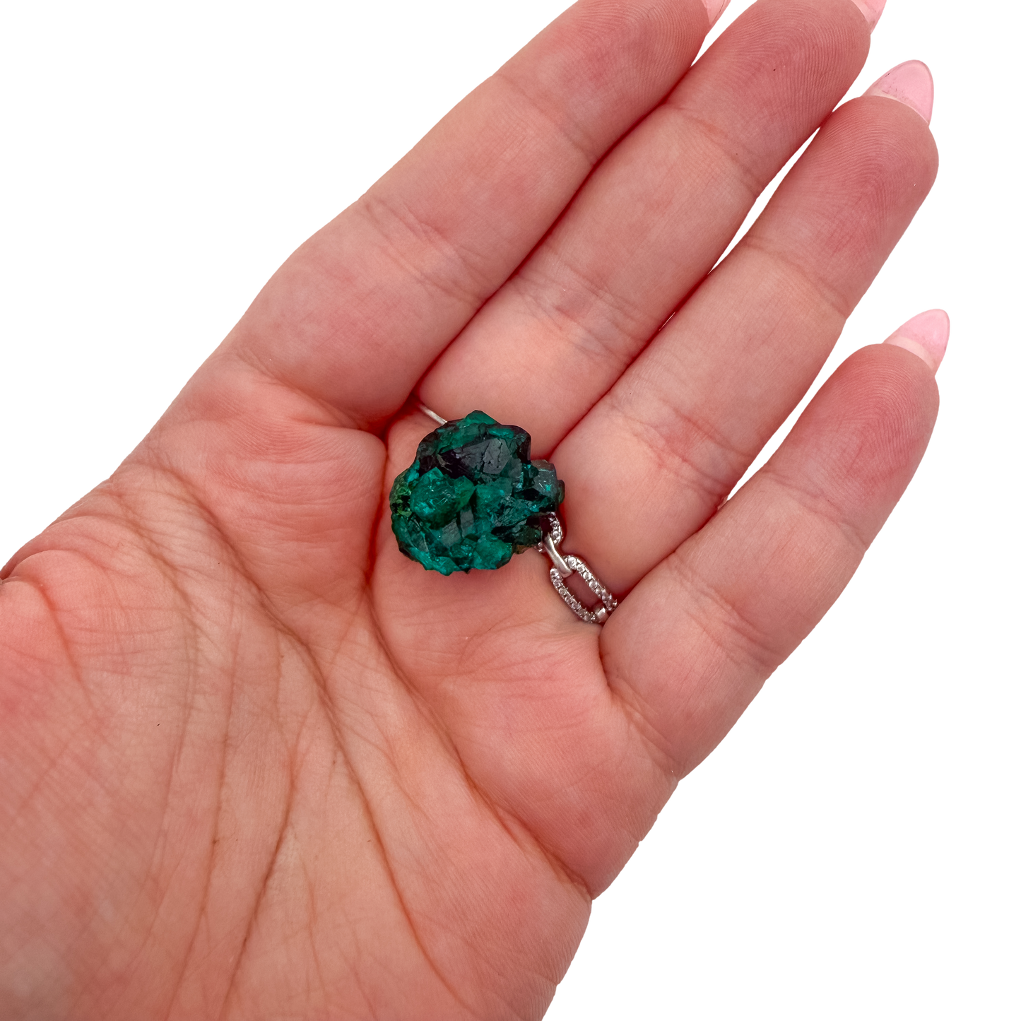 The elongated matrix held in a hand, showing the true scale of this 1.49 inch dioptase