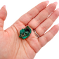 Scale shot of the deep teal cluster, 14.6 g of Congolese dioptase cupped in a hand