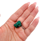 The chunky green matrix held in a hand, showing the true scale of this 1.12 inch dioptase