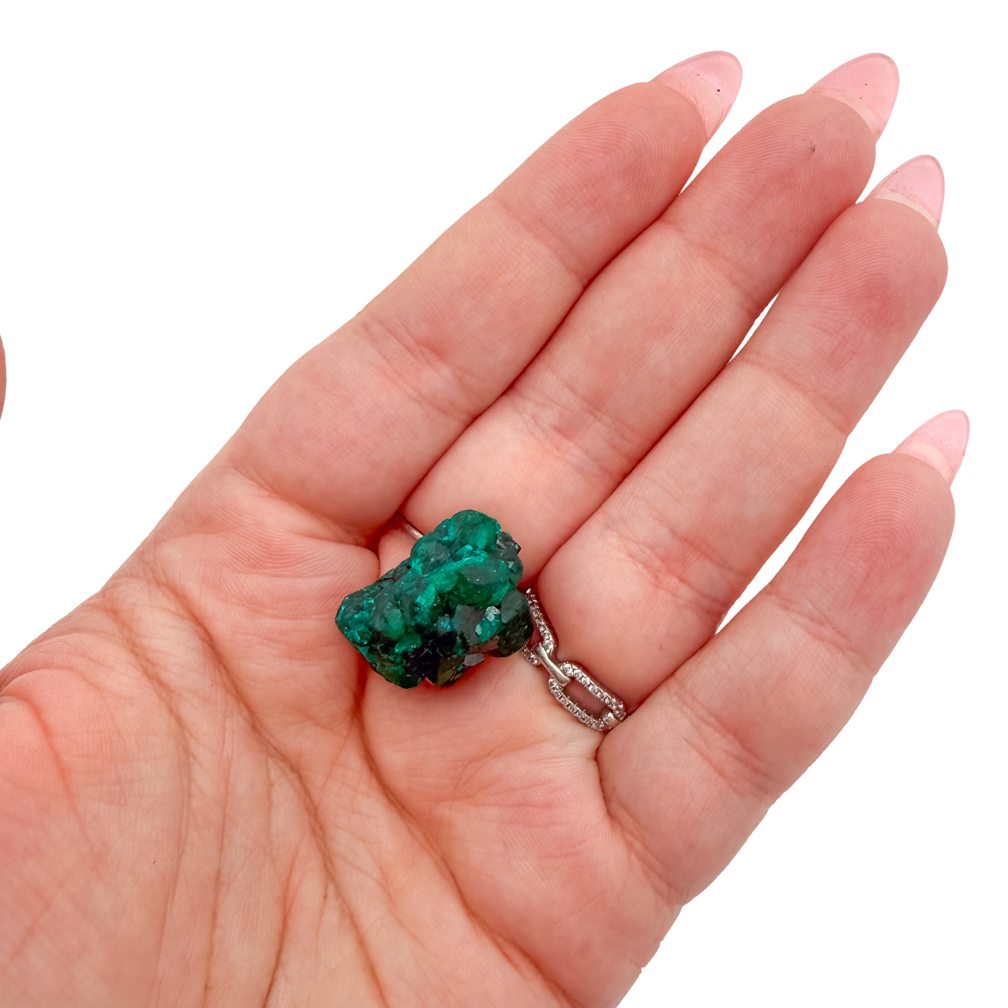 The chunky green matrix held in a hand, showing the true scale of this 1.12 inch dioptase