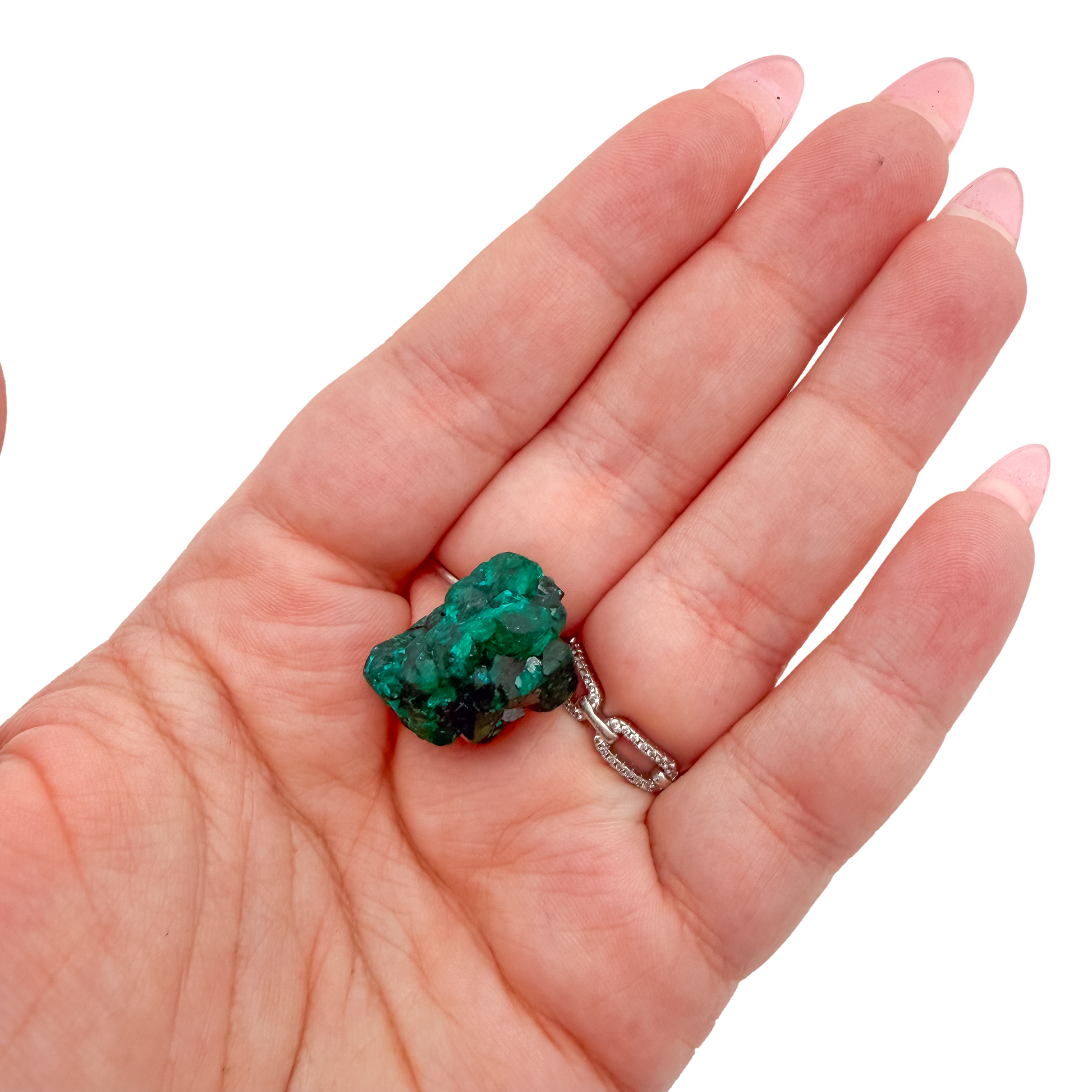The chunky green matrix held in a hand, showing the true scale of this 1.12 inch dioptase