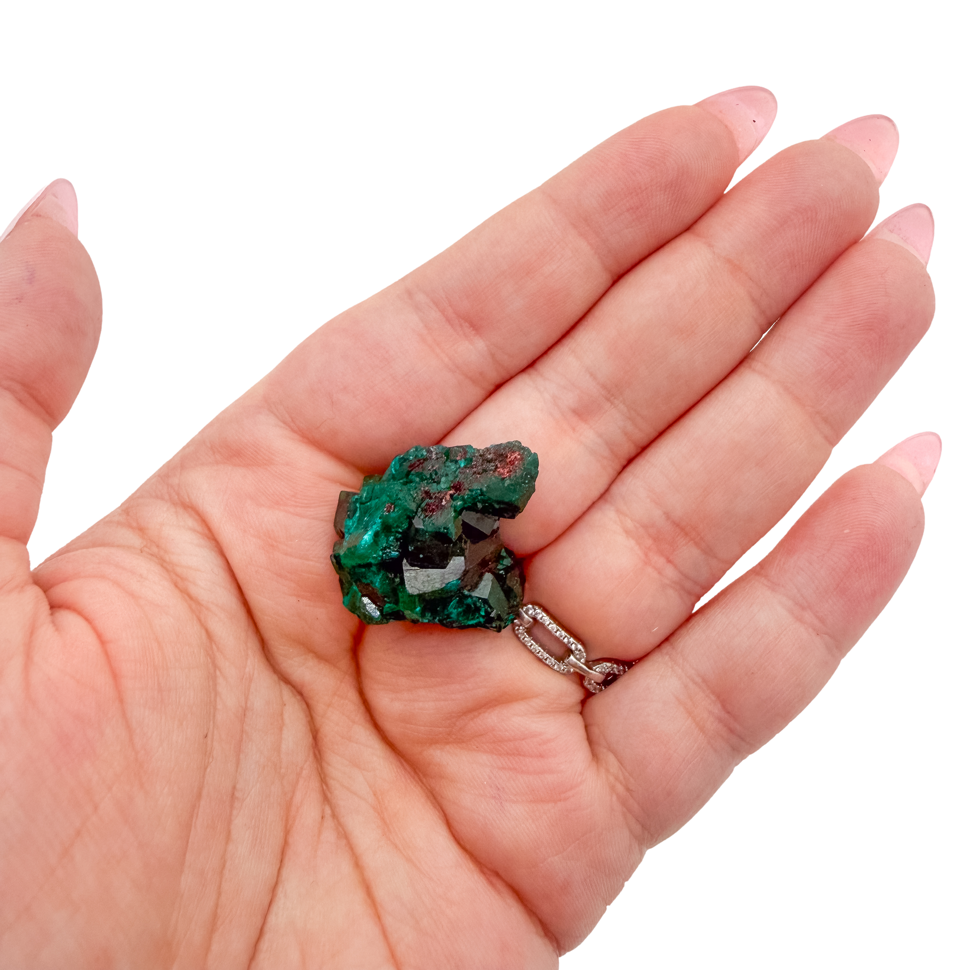 Hand holding the tall little block to show how small a 0.95 inch collector dioptase is