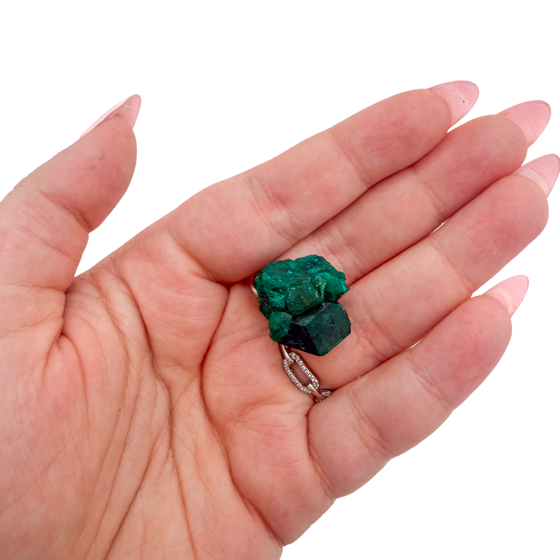 Scale shot of the glassy green face, 8.1 g of Congolese dioptase cupped in a hand