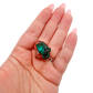 Hand holding the even green coverage to show how small a 0.89 inch collector dioptase is