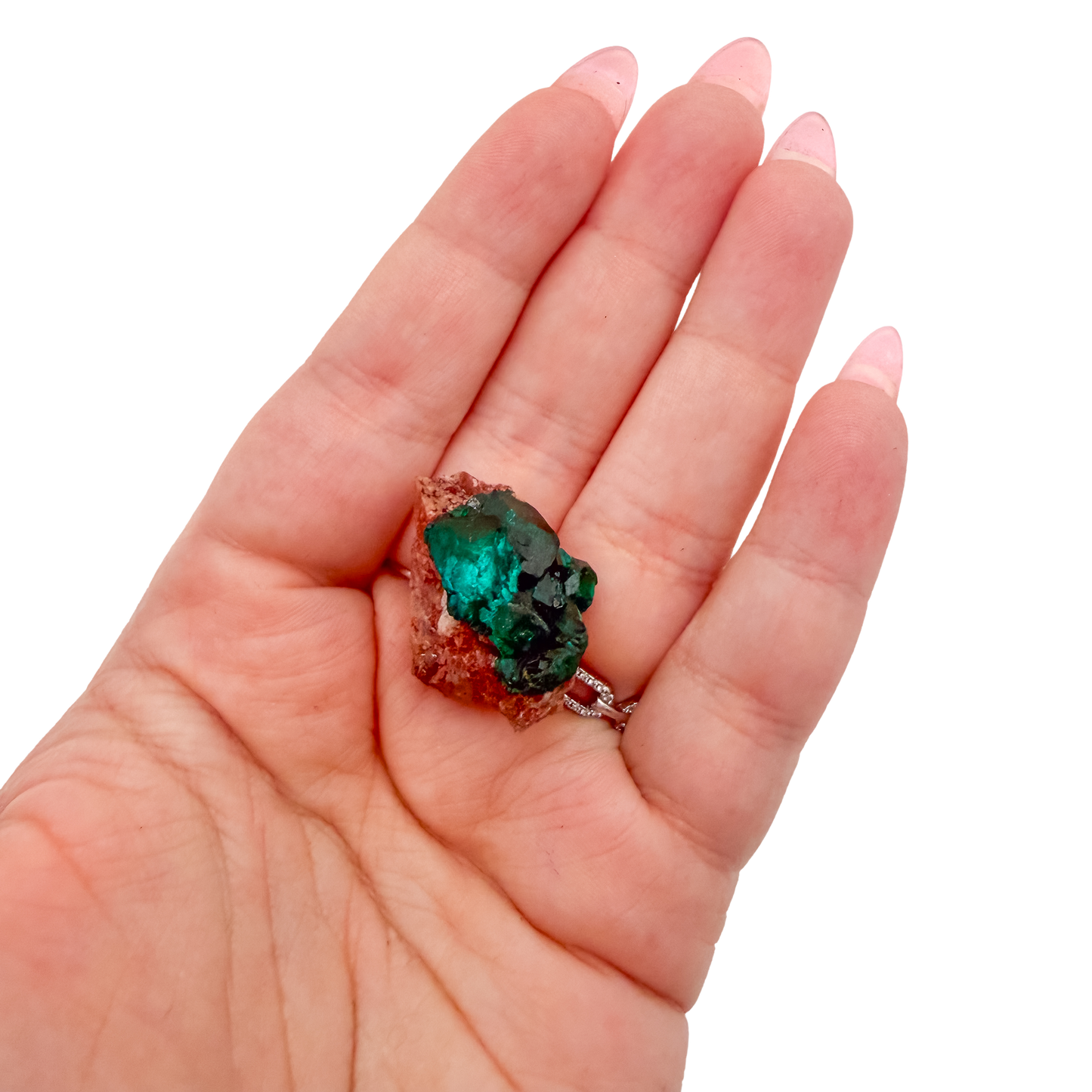 Hand holding the even green coverage to show how small a 0.89 inch collector dioptase is