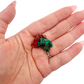 The broad thin plate held in a hand, showing the true scale of this 1.14 inch dioptase