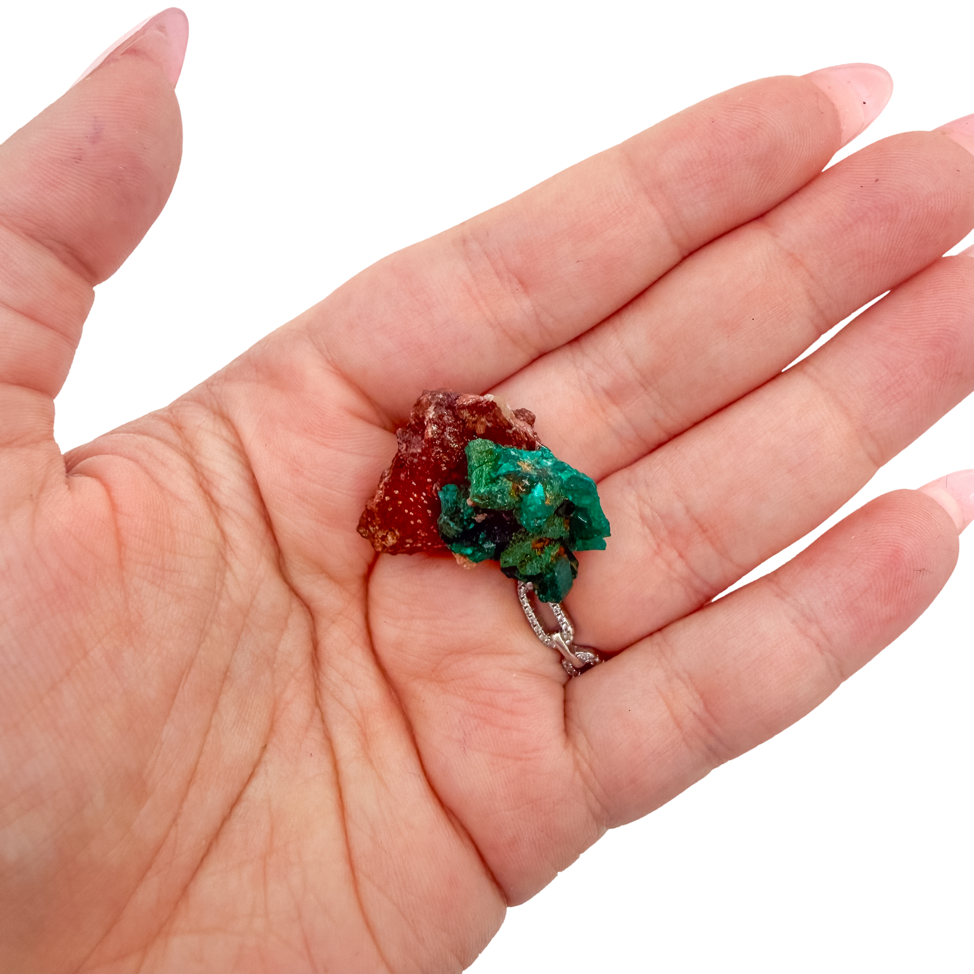 The broad thin plate held in a hand, showing the true scale of this 1.14 inch dioptase