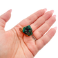 A 5.7 g dioptase, the petite collector piece, resting in an open palm for size