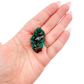 Hand holding the small square matrix to show how small a 0.78 inch collector dioptase is