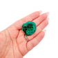 The dense little block held in a hand, showing the true scale of this 0.81 inch dioptase