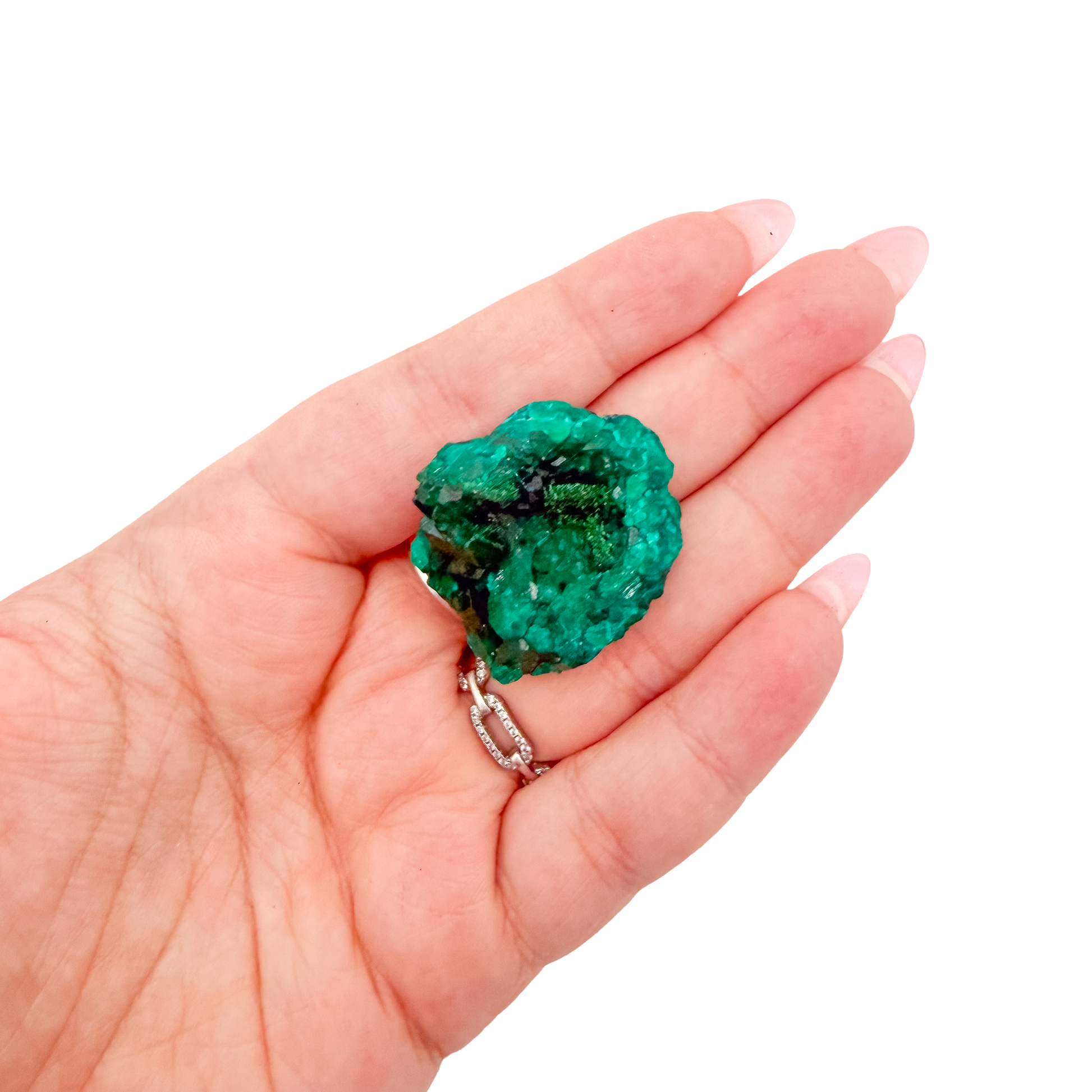 The dense little block held in a hand, showing the true scale of this 0.81 inch dioptase