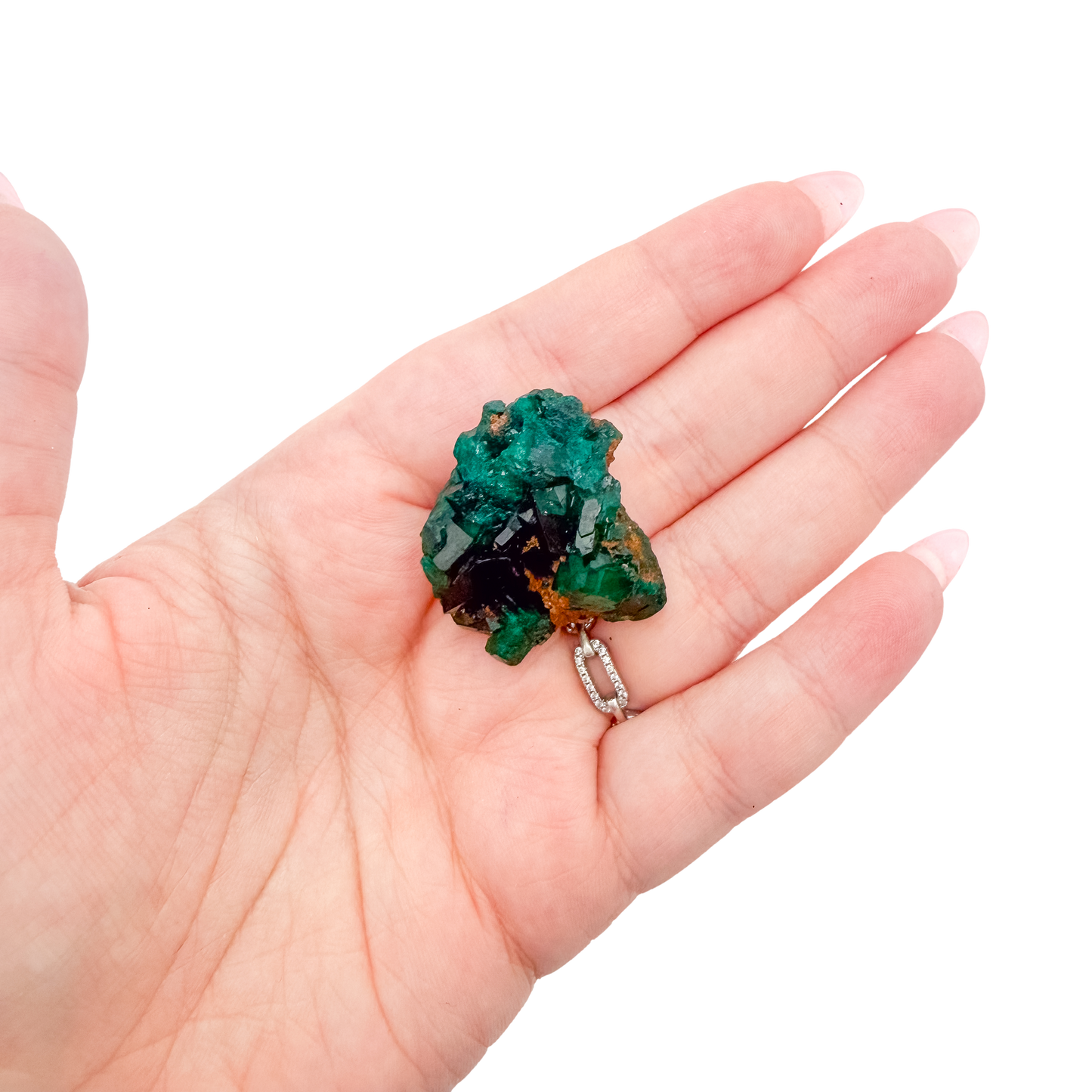 Scale shot of the bright slim piece, 7.5 g of Congolese dioptase cupped in a hand